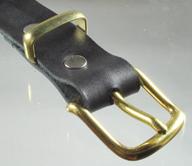 A brass plated dress buckle on a strap.